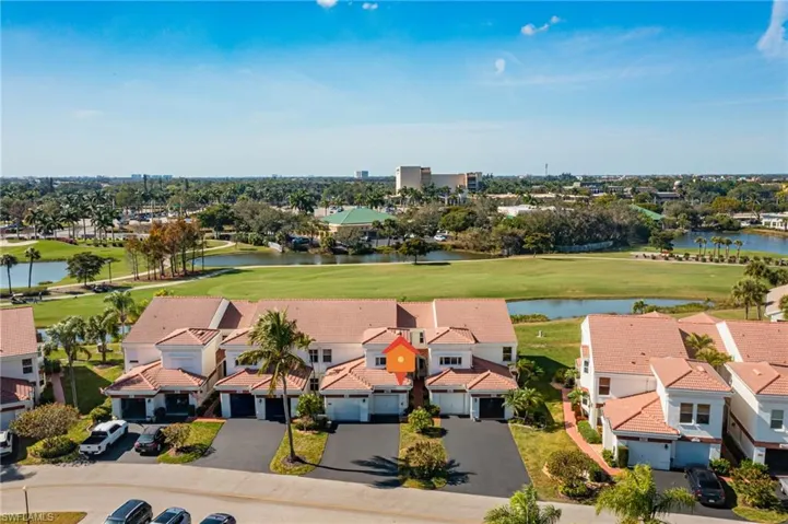 Aerial view of residential area with a local golf course and a large body of water