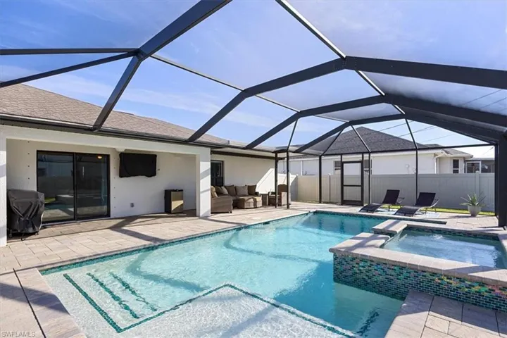 View of pool with a sunroom, a lanai, a patio area, and area for grilling