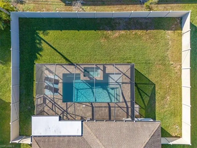 View of subject property with a pool area
