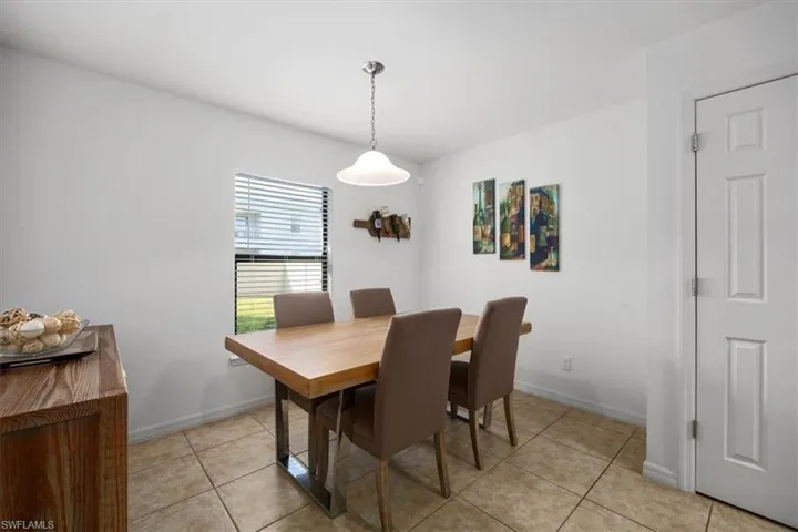 Dining space featuring light tile patterned floors