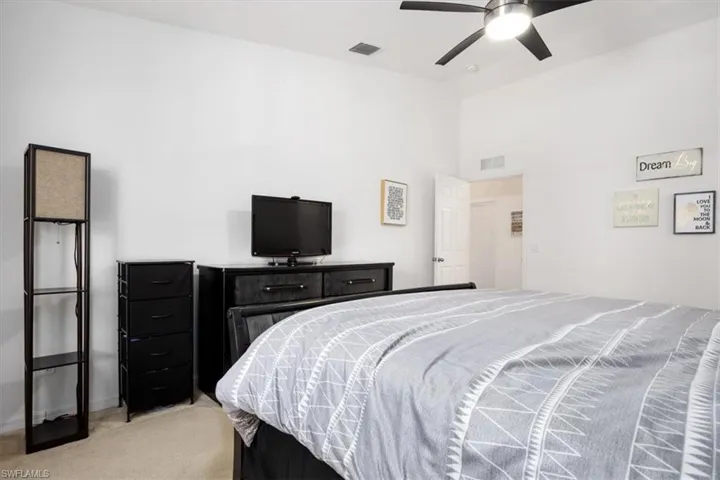 Bedroom featuring light colored carpet and ceiling fan
