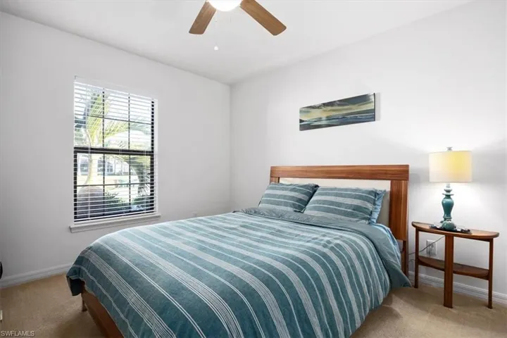 Bedroom featuring light colored carpet and ceiling fan