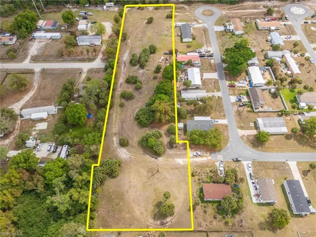 Aerial perspective of suburban area featuring property boundaries highlighted