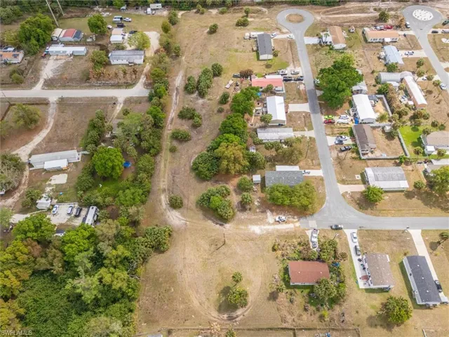 Aerial view of property and surrounding area featuring nearby suburban area