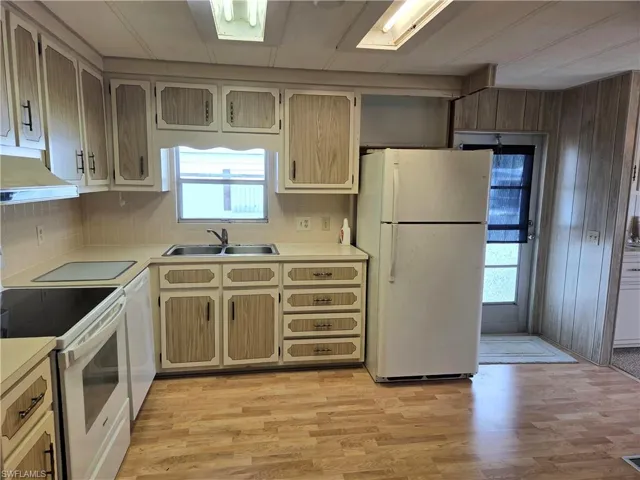 Bright, cheery Kitchen with smooth-top stove, fridge, and dishwasher.