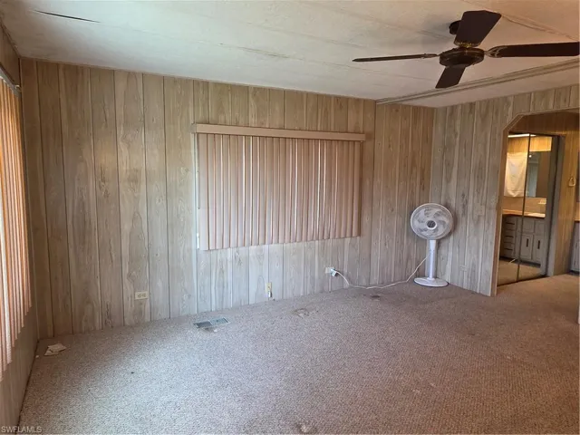 Primary Bedroom with neutral carpet and ceiling fan