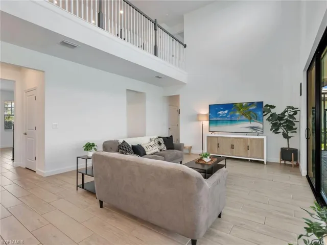 Living area featuring wood finish floors and a high ceiling