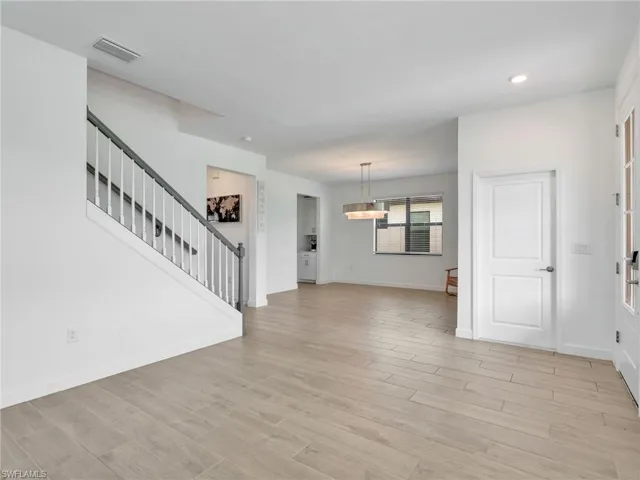 Unfurnished living room with light wood-style floors and recessed lighting