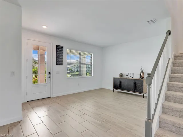 Foyer entrance with stairs and wood finish floors