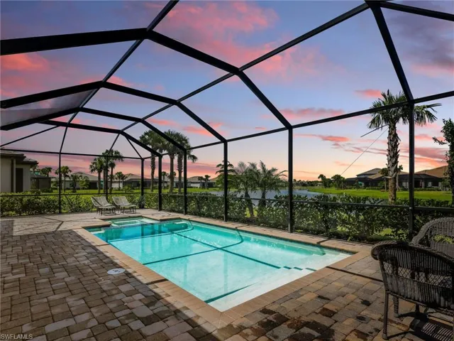 Integrated pool / hot tub featuring a sunroom, a lanai, and a patio