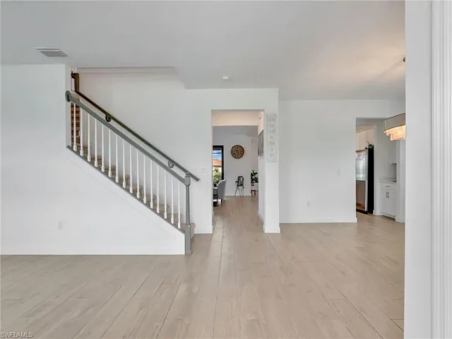 Foyer with stairs and light wood finished floors
