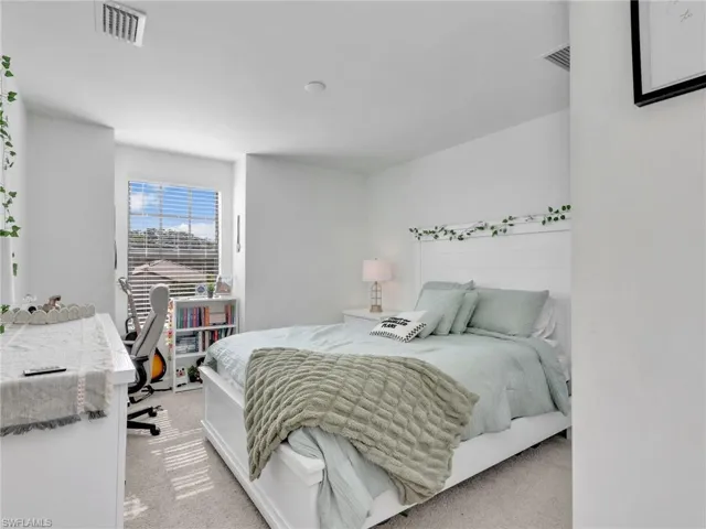 Bedroom with light carpet