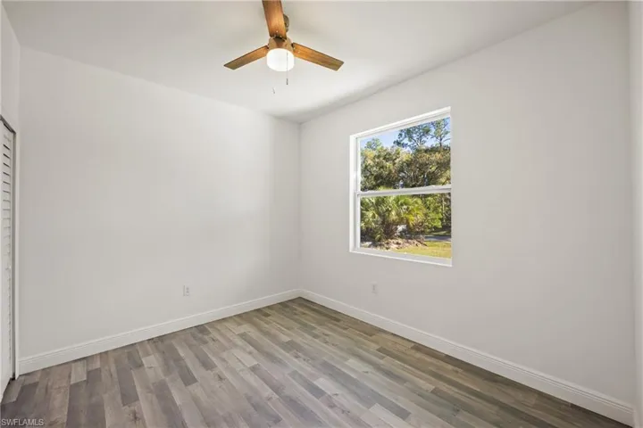 Unfurnished room featuring hardwood / wood-style floors and ceiling fan