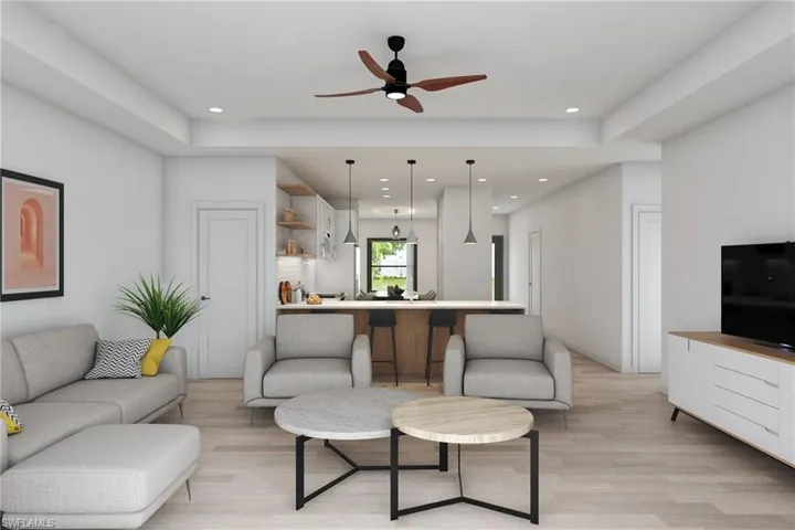 Living room featuring ceiling fan and light hardwood / wood-style floors