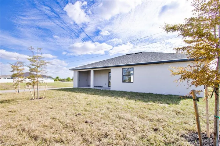 View of side of property featuring a yard