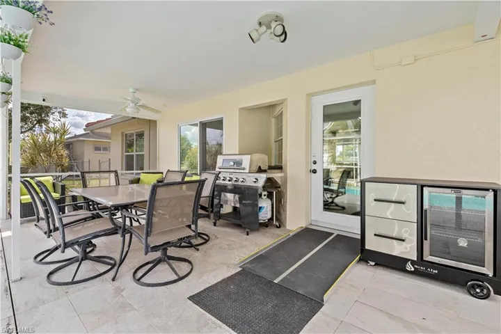 View of patio / terrace featuring area for grilling and ceiling fan