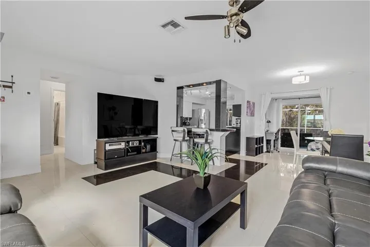 Living room featuring ceiling fan and light tile patterned floors