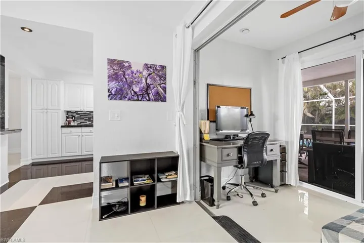 Office with ceiling fan and light tile patterned flooring
