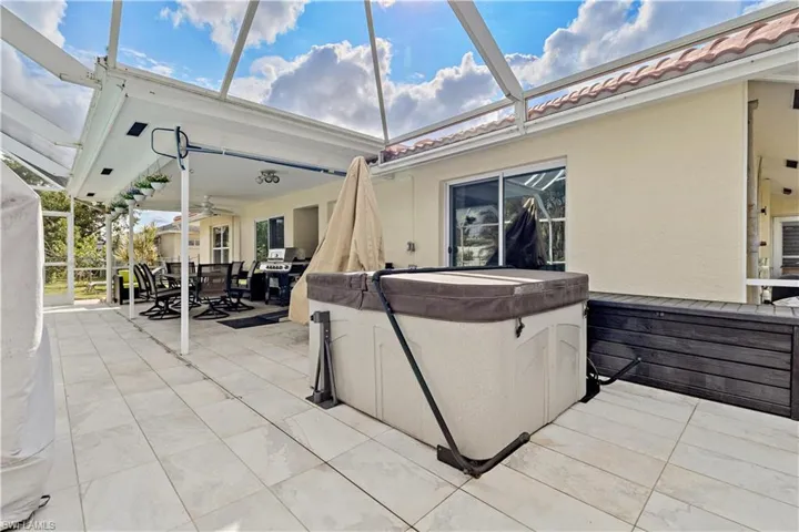 View of patio / terrace featuring a hot tub and ceiling fan