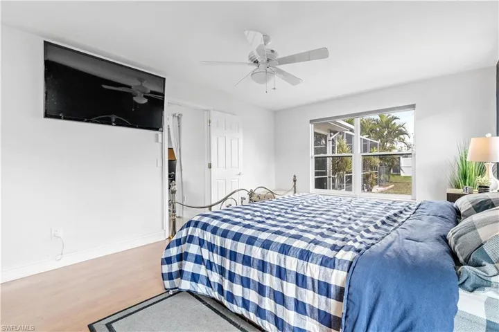 Bedroom featuring ceiling fan and light hardwood / wood-style flooring