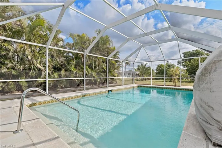 View of swimming pool with a patio area and a lanai