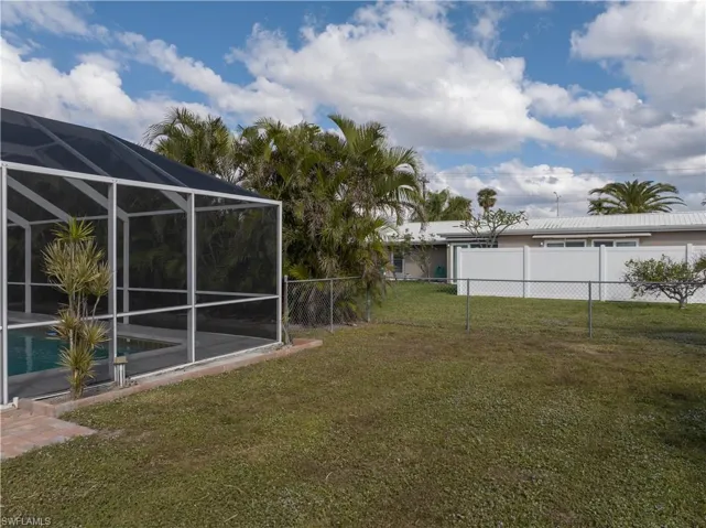 View of yard featuring glass enclosure