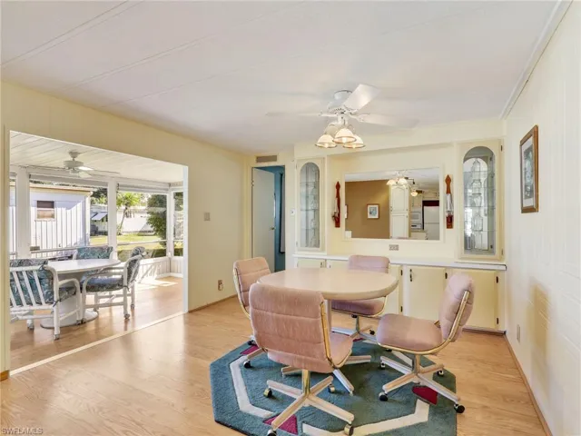 Dining room with light wood-style floors and ceiling fan