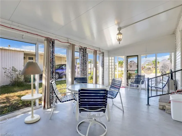 Sunroom / solarium with vaulted ceiling and concrete flooring