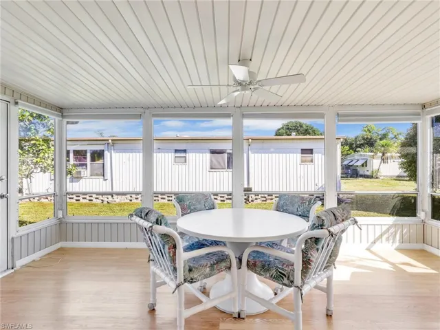 Sunroom with ceiling fan and outdoor dining space