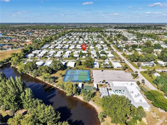 Aerial overview of property's location with a nearby body of water
