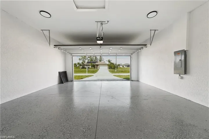 Garage featuring a textured wall and electric panel