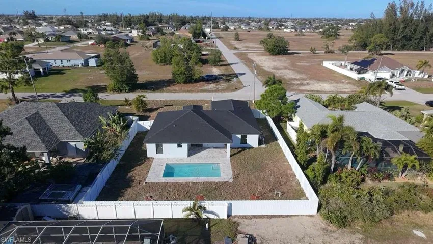Aerial view of residential area featuring a pool