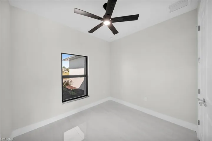 Spare room with baseboards and ceiling fan