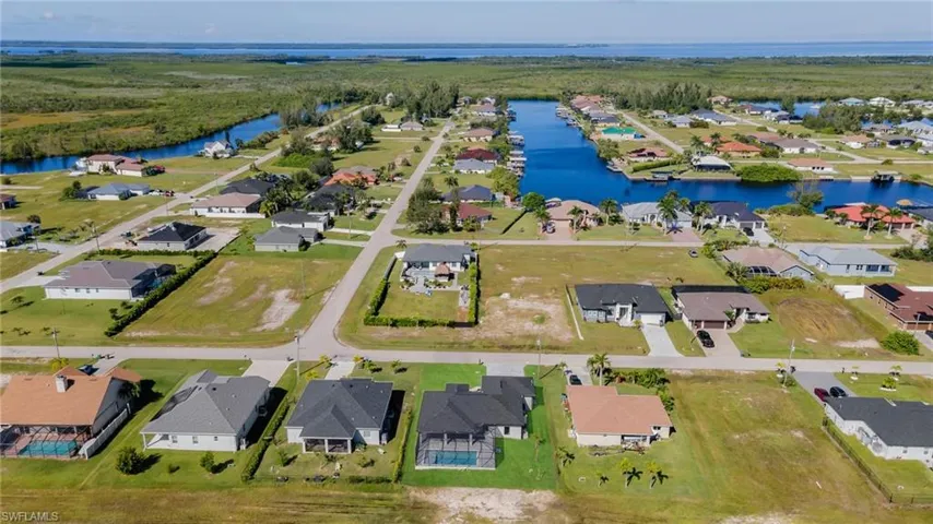 Aerial perspective of suburban area with a nearby body of water