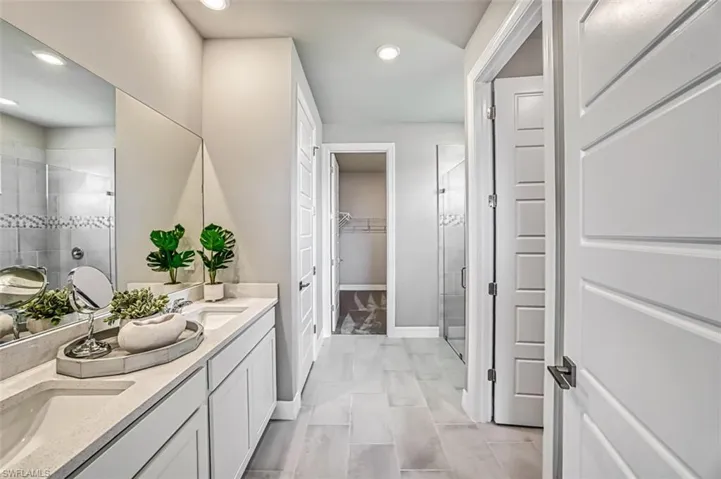 Master Bath with walk in shower, tile flooring, and double sink vanity