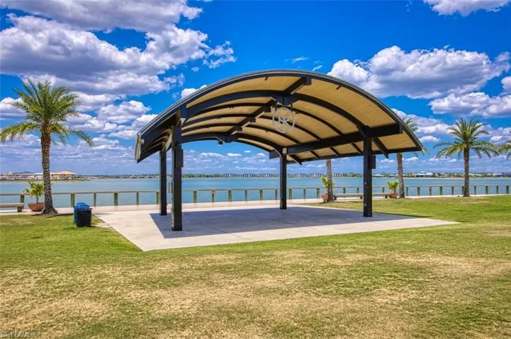 View of BR community featuring a water view, a gazebo, and a lawn