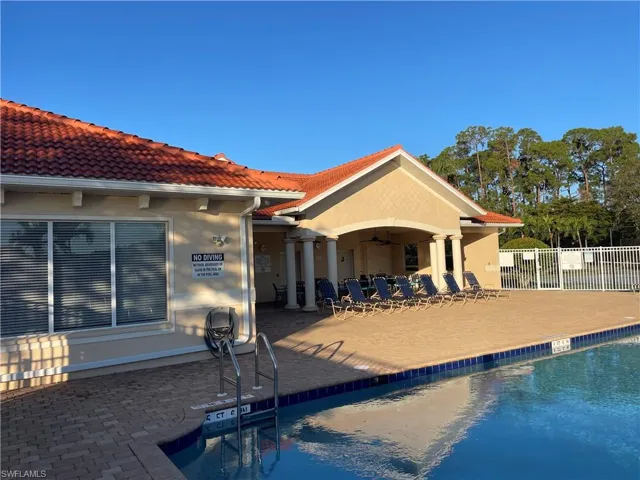 Back of house featuring a patio, ceiling fan, and a community pool