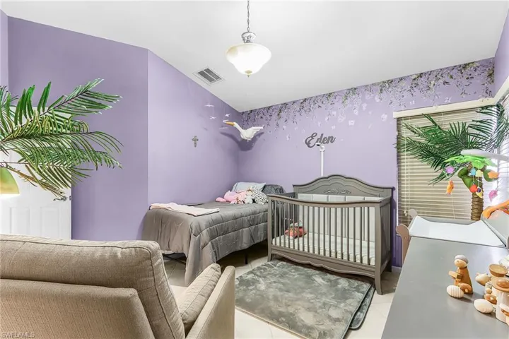 Bedroom featuring a crib