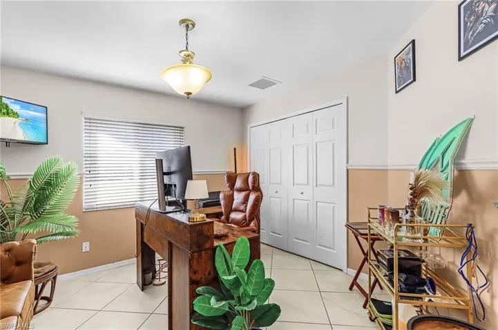 Office area with light tile patterned floors and baseboards