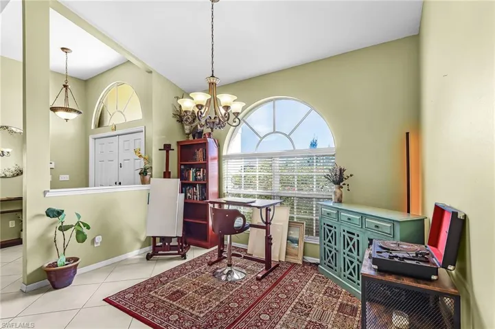 Sitting room featuring a chandelier and tile patterned floors