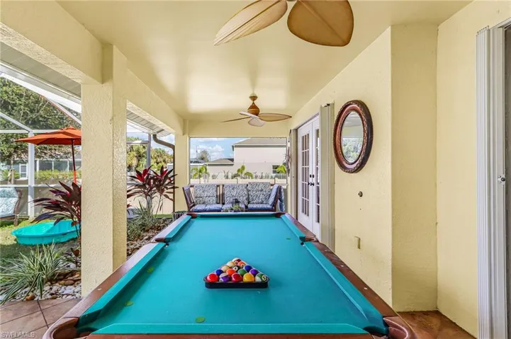 Game room with a textured wall and billiards table