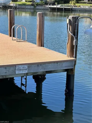 Dock area featuring a water view