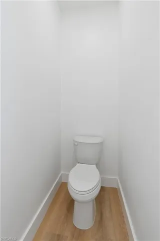 Bathroom with toilet and light wood-style floors