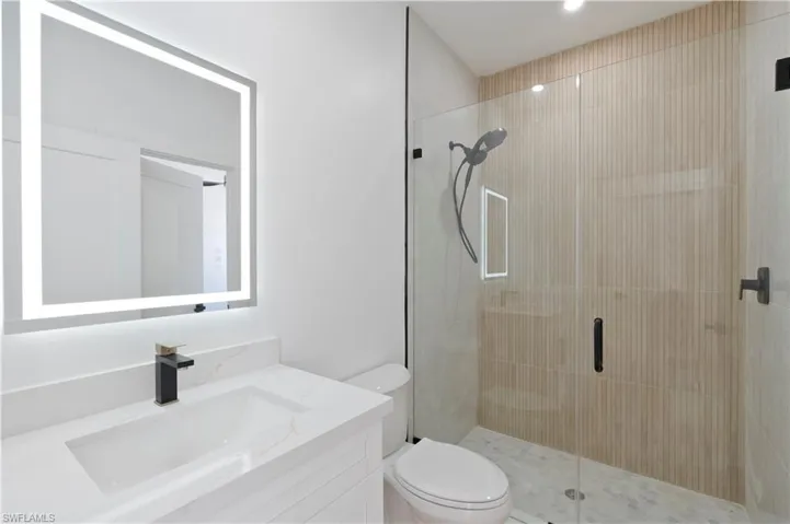 Bathroom with vanity and a shower stall