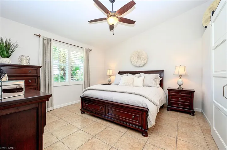 Master Bedroom with vaulted ceiling, light tile patterned floors, and modern ceiling fan