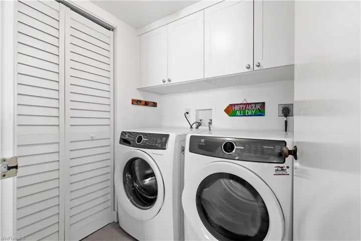 Laundry room with cabinets and washing machine and clothes dryer