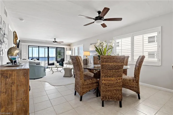 Tiled dining room featuring ceiling fan