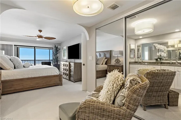 Carpeted bedroom featuring ceiling fan and sink