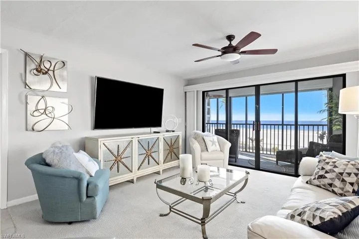 Living room featuring carpet flooring and ceiling fan