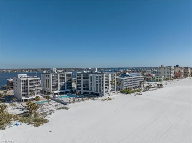 Birds eye view of property with a water view